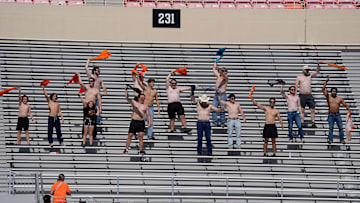 Oklahoma State fans cheer with their shirts off during a college football game between the Oklahoma State Cowboys (OSU) and the Houston Cougars at Boone Pickens Stadium in Stillwater, Okla., Saturday, Oct. 11, 2025. Houston won 39-17.
