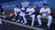 Dodgers James Outman, Jason Heyward, Freddie Freeman and Max Muncy sit in the home dugout at Dodger Stadium. Muncy was placed on the injured list, Heyward was activated from the IL, and Outman was demoted to Triple-A Oklahoma City on Friday.