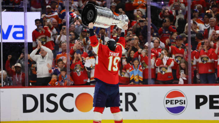 Jun 24, 2024; Sunrise, Florida, USA; Florida Panthers forward Matthew Tkachuk (19) hoists the Stanley Cup after defeating the Edmonton Oilers in game seven of the 2024 Stanley Cup Final at Amerant Bank Arena. Mandatory Credit: Sam Navarro-USA TODAY Sports