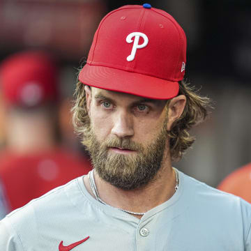 Aug 20, 2024; Cumberland, Georgia, USA; Philadelphia Phillies first baseman Bryce Harper (3) in the dugout prior to the game against the Atlanta Braves at Truist Park