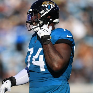 Jacksonville Jaguars offensive tackle Cam Robinson (74) walks off the field after being ejected for fighting with Carolina Panthers defensive tackle Derrick Brown (95), not shown, during the fourth quarter of a regular season NFL football matchup Sunday, Dec. 31, 2023 at EverBank Stadium in Jacksonville, Fla. The Jacksonville Jaguars blanked the Carolina Panthers 26-0. [Corey Perrine/Florida Times-Union]