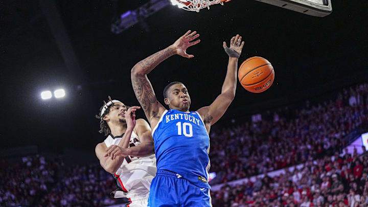 Jan 7, 2025; Athens, Georgia, USA; Kentucky Wildcats forward Brandon Garrison (10) dunks behind Georgia Bulldogs forward Asa Newell (14) during the second half at Stegeman Coliseum. Mandatory Credit: Dale Zanine-Imagn Images