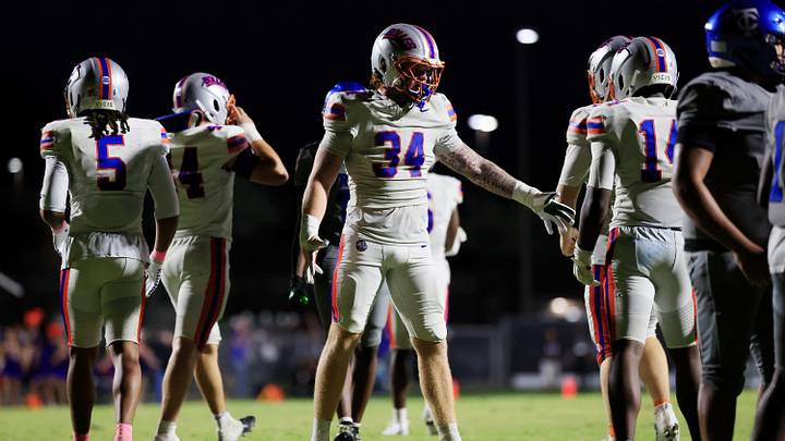 Bolles' Asher Ghioto (34) high-fives players during the third quarter of a high school football matchup at Trinity Christian Academy on Friday, Oct. 16, 2026 in Jacksonville, Fla. Trinity Christian edged Bolles 20-17 in overtime.