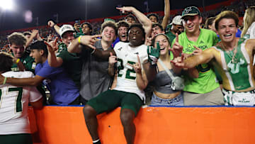 South Florida cornerback De'Shawn Rucker celebrates with USF fans who made the trip to Gainesville to watch the Bulls defeat Florida.