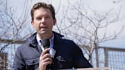 Apr 13, 2025; Minneapolis, Minnesota, USA; Minnesota Twins executive chair Joe Pohlad addresses the crowd as the team unveils a statue of Joe Mauer before the game with the Detroit Tigers at Target Field. Mandatory Credit: Bruce Kluckhohn-Imagn Images