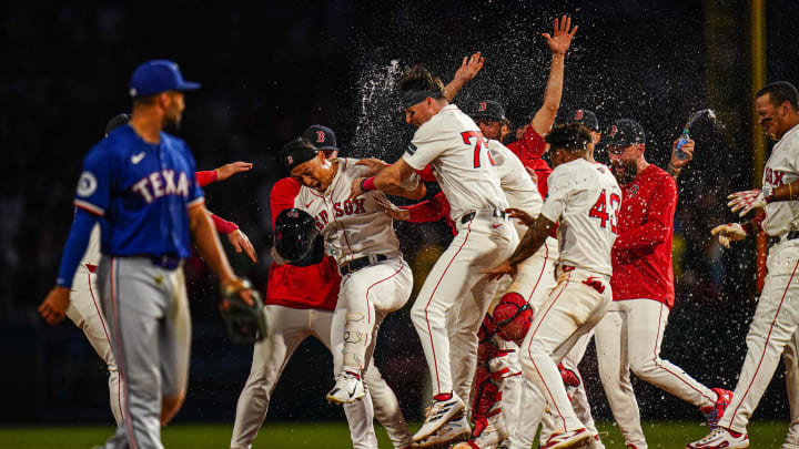 Aug 12, 2024; Boston, Massachusetts, USA; Boston Red Sox left fielder Rob Refsnyder (30) is congratulated after singling to center field to drive in the winning run against the Texas Rangers in the tenth inning at Fenway Park. Mandatory Credit: David Butler II-USA TODAY Sports