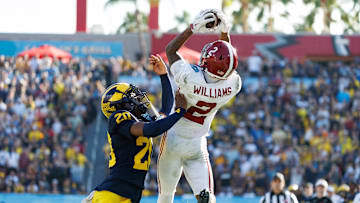 Dec 31, 2024; Tampa, FL, USA; Alabama Crimson Tide wide receiver Ryan Williams (2) makes a catch while Michigan Wolverines defensive back Jyaire Hill (20) pushes him out of bounds during the second half at Raymond James Stadium. Mandatory Credit: Matt Pendleton-Imagn Images