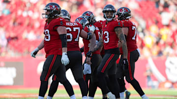 Dec 31, 2023; Tampa, Florida, USA;  Tampa Bay Buccaneers quarterback Baker Mayfield (6) is helped off the field by offensive tackle Luke Goedeke (67) against the New Orleans Saints in the fourth quarter at Raymond James Stadium. Mandatory Credit: Nathan Ray Seebeck-Imagn Images