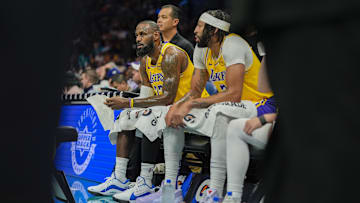 Jan 27, 2025; Charlotte, North Carolina, USA; Los Angeles Lakers forward Anthony Davis (3) and Los Angeles Lakers forward LeBron James (23) during a timeout against the Charlotte Hornets during the first quarter at the Spectrum Center. Mandatory Credit: Jim Dedmon-Imagn Images