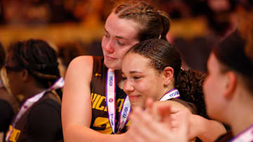 Kickapoo's Allison Scott (32) hugs Kya Johnson (33) after receiving second place medals following a Class 6 state championship girls basketball game between Kickapoo and Incarnate Word, Saturday, March 16, 2024, at Mizzou Arena in Columbia, Mo.