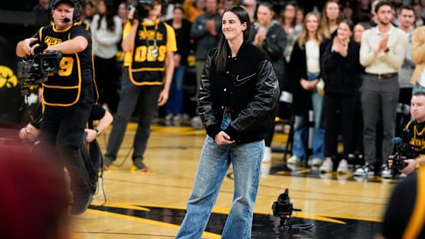 Caitlin Clark stands at center court for her jersey retirement ceremony Sunday, Feb. 2, 2025 at Carver-Hawkeye Arena in Iowa