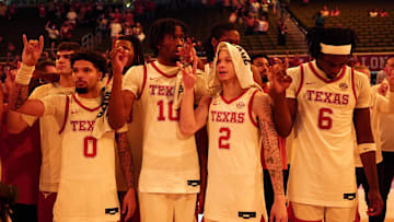 Dec 15, 2024; Austin, Texas, USA; Texas Longhorns guard Jordan Pope (0), forward Nic Codie (10), guard Chendall Weaver (2) and forward Arthur Kaluma (6) stand for the Eyes of Texas.