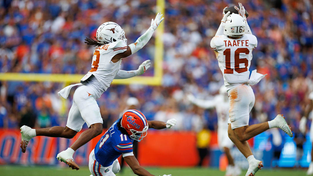 Oct 4, 2025; Gainesville, Florida, USA; Texas Longhorns defensive back Michael Taaffe (16) intercepts a pass to Florida Gators wide receiver Aidan Mizell (11) during the second half at Ben Hill Griffin Stadium. Mandatory Credit: Matt Pendleton-Imagn Images