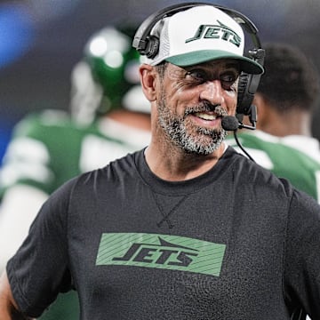 Aug 17, 2024; Charlotte, North Carolina, USA;  New York Jets quarterback Aaron Rodgers (8) shares a laugh on the sidelines during the second half against the Carolina Panthers at Bank of America Stadium.