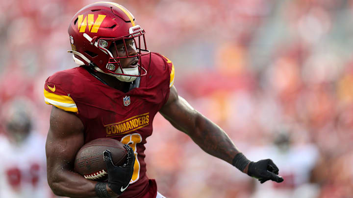 Sep 8, 2024; Tampa, Florida, USA; Washington Commanders running back Brian Robinson Jr. (8) runs with the ball against the Tampa Bay Buccaneers in the third quarter at Raymond James Stadium. Mandatory Credit: Nathan Ray Seebeck-Imagn Images