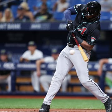 Aug 16, 2024; St. Petersburg, Florida, USA; Arizona Diamondbacks first baseman Josh Bell (36) hits an rbi single against the Tampa Bay Rays in the first inning at Tropicana Field. Mandatory Credit: Nathan Ray Seebeck-USA TODAY Sports