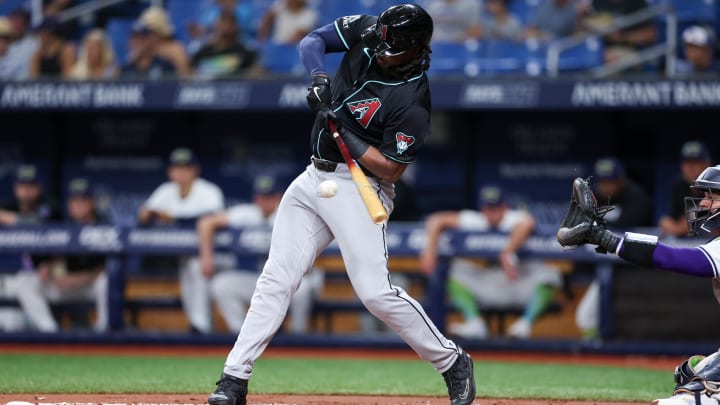 Aug 16, 2024; St. Petersburg, Florida, USA; Arizona Diamondbacks first baseman Josh Bell (36) hits an rbi single against the Tampa Bay Rays in the first inning at Tropicana Field. Mandatory Credit: Nathan Ray Seebeck-USA TODAY Sports