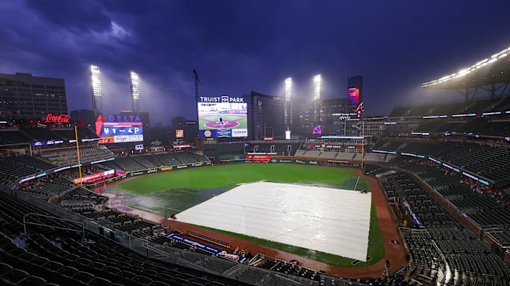 The tarp covers the field during a rain delay at Truist Park