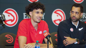 Jun 28, 2024; Atlanta, Georgia, USA; Atlanta Hawks draft pick Zaccharie Risacher, left, talks to the media as general manager Landry Fields looks on at the Emory Sports Medicine Complex. Mandatory Credit: Brett Davis-USA TODAY Sports