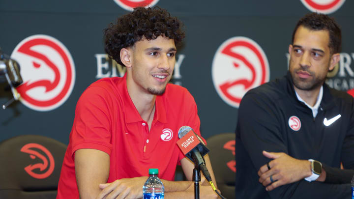 Jun 28, 2024; Atlanta, Georgia, USA; Atlanta Hawks draft pick Zaccharie Risacher, left, talks to the media as general manager Landry Fields looks on at the Emory Sports Medicine Complex. Mandatory Credit: Brett Davis-USA TODAY Sports