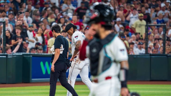 Aug 10, 2024; Phoenix, Arizona, USA; A general view as Arizona Diamondbacks infielder Ketel Marte (4) is escorted off the field after a collision with Philadelphia Phillies catcher Garrett Stubbs (21) (not shown) at second base in the fourth inning during a game at Chase Field. Mandatory Credit: Allan Henry-USA TODAY Sports  