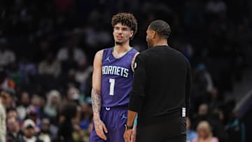 Mar 20, 2025; Charlotte, North Carolina, USA; Charlotte Hornets guard LaMelo Ball (1) talks with head coach Charles Lee  during a  free throw during the second half against the New York Knicks at Spectrum Center. Mandatory Credit: Jim Dedmon-Imagn Images