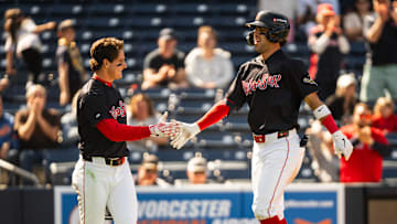 WooSox player Roman Anthony (left) high fives teammate Marcelo Mayer during a Triple-A game at Polar Park on April 23, 2025.
