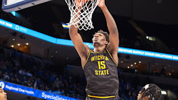 Jan 23, 2025; Memphis, Tennessee, USA; Wichita State Shockers center Quincy Ballard (15) dunks the ball against the Memphis Tigers during the second half at FedExForum. Mandatory Credit: Wesley Hale-Imagn Images