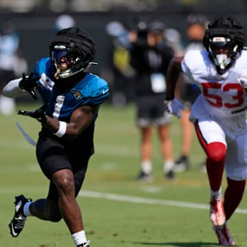 Jacksonville Jaguars running back Travis Etienne Jr. (1) hauls in a reception against Tampa Bay Buccaneers linebacker Vi Jones (53) during a combined NFL football training camp session between the Tampa Bay Buccaneers and Jacksonville Jaguars Wednesday, Aug. 14, 2024 at EverBank Stadium’s Miller Electric Center in Jacksonville, Fla. [Corey Perrine/Florida Times-Union]