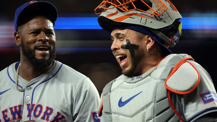 New York Mets pitcher Luis Severino (40) (L) and catcher Francisco Alvarez (4) walk off the field