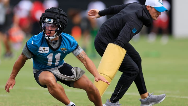 Jacksonville Jaguars wide receiver Parker Washington (11) is pressured by assistant wide receivers coach, passing game specialist Tyler Tettleton during a combined NFL football training camp session between the Tampa Bay Buccaneers and Jacksonville Jaguars Thursday, Aug. 15, 2024 at EverBank Stadium’s Miller Electric Center in Jacksonville, Fla.