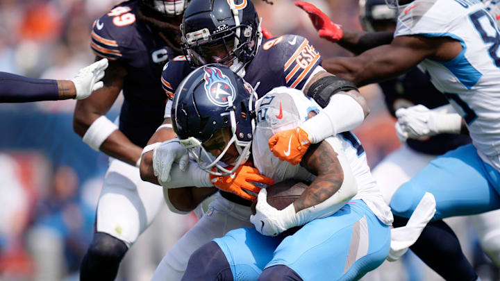 Tennessee Titans running back Tony Pollard (20) is wrapped up by Chicago Bears safety Jaquan Brisker (9) during the third quarter at Soldier Field in Chicago, Ill., Sunday, Sept. 8, 2024.