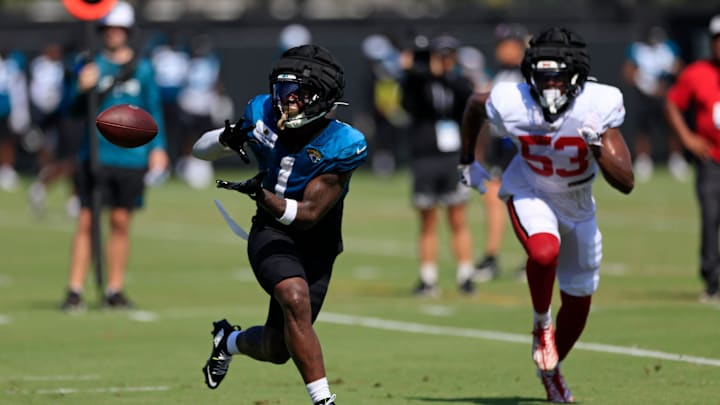 Jacksonville Jaguars running back Travis Etienne Jr. (1) hauls in a reception against Tampa Bay Buccaneers linebacker Vi Jones (53) during a combined NFL football training camp session between the Tampa Bay Buccaneers and Jacksonville Jaguars Wednesday, Aug. 14, 2024 at EverBank Stadium’s Miller Electric Center in Jacksonville, Fla. [Corey Perrine/Florida Times-Union]