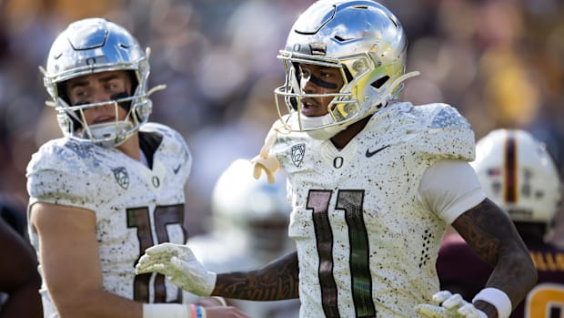 Nov 18, 2023; Tempe, Arizona, USA; Oregon Ducks wide receiver Troy Franklin (11) with quarterback Bo Nix (10) against the Ari