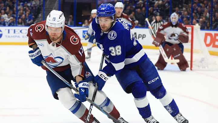 Jan 6, 2026; Tampa, Florida, USA; Colorado Avalanche right wing Valeri Nichushkin (13) and Tampa Bay Lightning left wing Brandon Hagel (38) skate after the puck during the third period at Benchmark International Arena. Mandatory Credit: Kim Klement Neitzel-Imagn Images