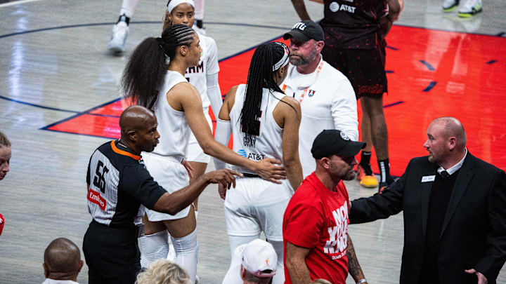 Sep 16, 2025; Indianapolis, Indiana, USA;  Atlanta Dream guard Allisha Gray (15) has a Indiana Fever fan thrown out  during game two of round one for the 2025 WNBA Playoffs at Gainbridge Fieldhouse. Mandatory Credit: Trevor Ruszkowski-Imagn Images