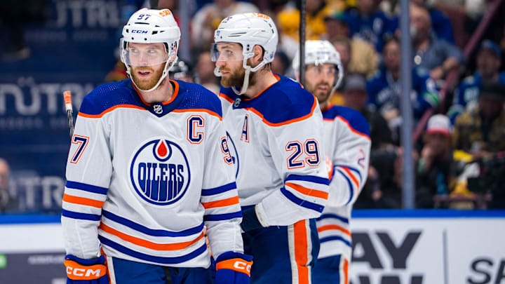 May 16, 2024; Vancouver, British Columbia, CAN; Edmonton Oilers forward Connor McDavid (97) and forward Leon Draisaitl (29) and defenseman Evan Bouchard (2) during a stop in play against the Vancouver Canucks during the first period in game five of the second round of the 2024 Stanley Cup Playoffs at Rogers Arena. Mandatory Credit: Bob Frid-USA TODAY Sports