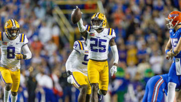 Nov 11, 2023; Baton Rouge, Louisiana, USA; LSU Tigers safety Javien Toviano (25) recovers a fumble against the Florida Gators during the first half at Tiger Stadium. Mandatory Credit: Stephen Lew-USA TODAY Sports