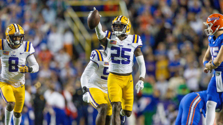 Nov 11, 2023; Baton Rouge, Louisiana, USA; LSU Tigers safety Javien Toviano (25) recovers a fumble against the Florida Gators during the first half at Tiger Stadium. Mandatory Credit: Stephen Lew-USA TODAY Sports