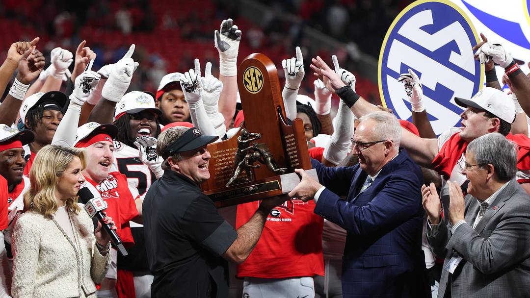Dec 6, 2025; Atlanta, GA, USA; Georgia Bulldogs head coach Kirby Smart lifts the SEC Championship trophy after the game against the Alabama Crimson Tide during the 2025 SEC Championship game at Mercedes-Benz Stadium. Mandatory Credit: Brett Davis-Imagn Images