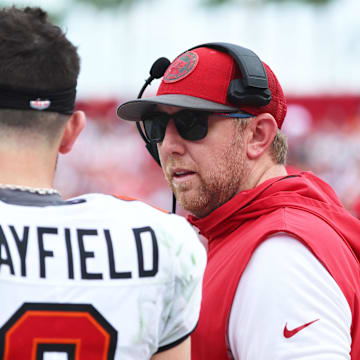 Sep 8, 2024; Tampa, Florida, USA;  Tampa Bay Buccaneers quarterback Baker Mayfield (6) talks with offensive coordinator Liam Coen against the Washington Commanders during the first half at Raymond James Stadium. Mandatory Credit: Kim Klement Neitzel-Imagn Images