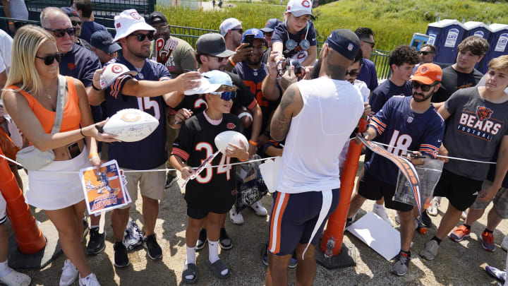 Wide receiver Keenan Allen signs autographs for fans after a Bears training camp practice at Halas Hall.