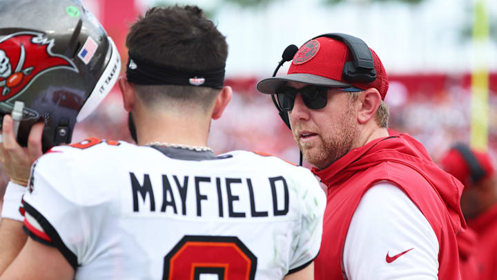 Sep 8, 2024; Tampa, Florida, USA;  Tampa Bay Buccaneers quarterback Baker Mayfield (6) talks with offensive coordinator Liam Coen against the Washington Commanders during the first half at Raymond James Stadium. Mandatory Credit: Kim Klement Neitzel-Imagn Images