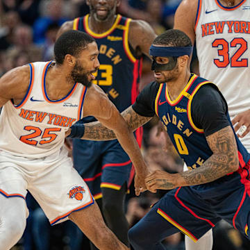 Mar 15, 2025; San Francisco, California, USA; New York Knicks forward Mikal Bridges (25) controls the basketball against Golden State Warriors guard Gary Payton II (0) during the fourth quarter at Chase Center. Mandatory Credit: Neville E. Guard-Imagn Images