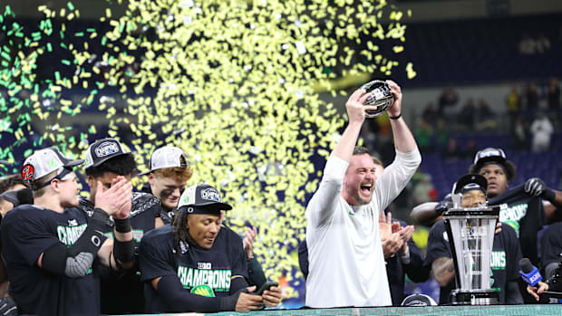 Dec 7, 2024; Indianapolis, IN, USA; Oregon Ducks head coach Dan Lanning and the Oregon Ducks celebrate defeating the Penn Sta
