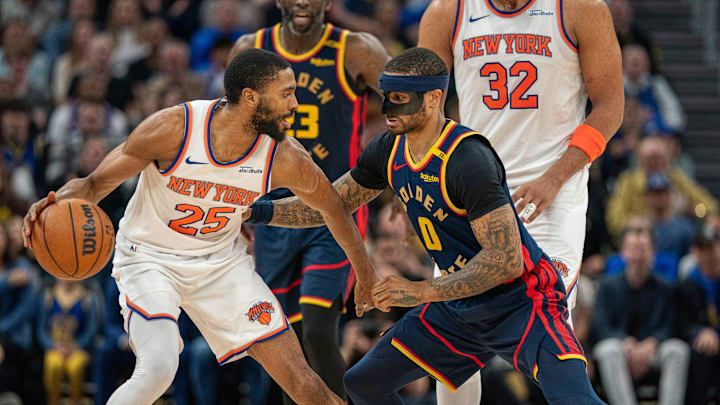 Mar 15, 2025; San Francisco, California, USA; New York Knicks forward Mikal Bridges (25) controls the basketball against Golden State Warriors guard Gary Payton II (0) during the fourth quarter at Chase Center. Mandatory Credit: Neville E. Guard-Imagn Images