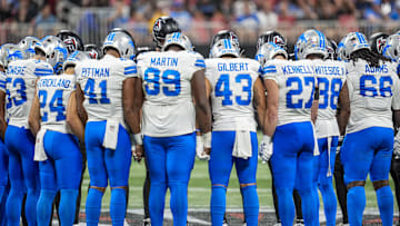 Detroit Lions and Atlanta Falcons players react on the field after an injury to Lions safety Morice Norris (26).