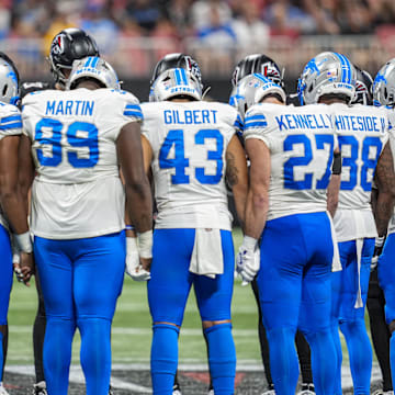 Detroit Lions and Atlanta Falcons players react on the field after an injury to Lions safety Morice Norris (26).