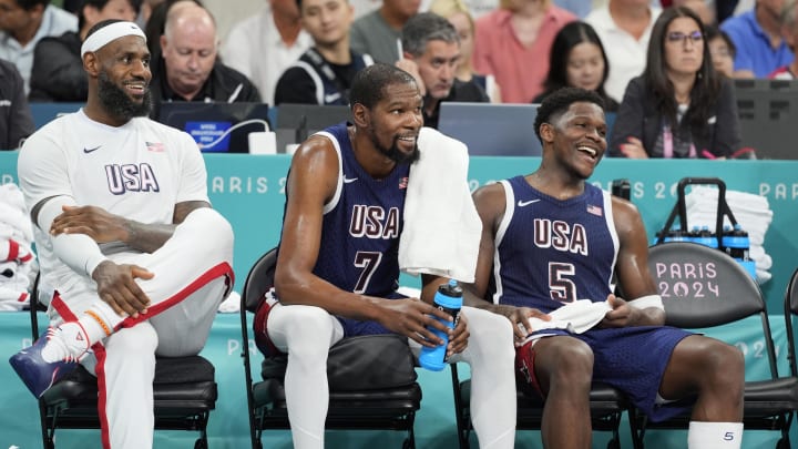 Aug 3, 2024; Villeneuve-d'Ascq, France; United States guard LeBron James (6), guard Kevin Durant (7) and guard Anthony Edwards (5) on the bench in the fourth quarter against Puerto Rico during the Paris 2024 Olympic Summer Games at Stade Pierre-Mauroy.