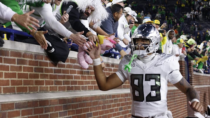 Nov 2, 2024; Ann Arbor, Michigan, USA;  Oregon Ducks tight end Roger Saleapaga (83) celebrates with fans after the game against the Michigan Wolverines at Michigan Stadium. Mandatory Credit: Rick Osentoski-Imagn Images